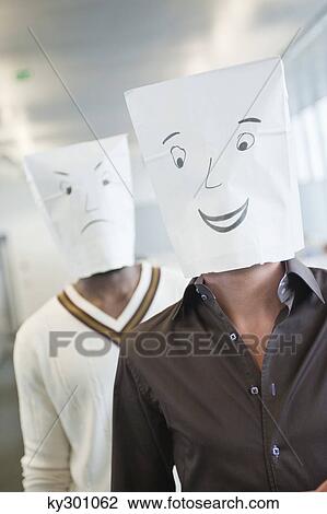 Two businessmen wearing paper bags of happy and sad faces View Large Photo Image Stock Image - Two businessmen wearing paper bags of happy and sad faces. Fotosearch