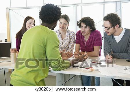 Business executives discussing in an office View Large Photo Image Stock Image - Business executives discussing in an office. Fotosearch
