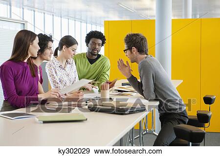 Business executives discussing in an office View Large Photo Image Stock Photo - Business executives discussing in an office. Fotosearch