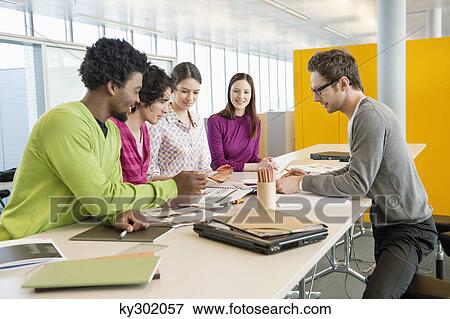 Business executives discussing in an office View Large Photo Image Stock Photo - Business executives discussing in an office. Fotosearch