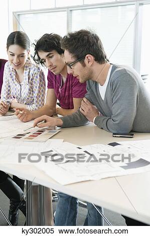 Business executives discussing in an office View Large Photo Image Stock Photography - Business executives discussing in an office. Fotosearch
