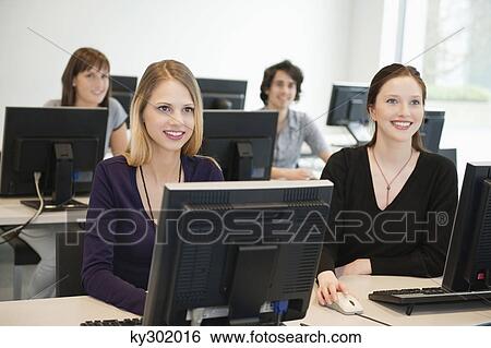 Business executives smiling in a training class View Large Photo Image Stock Photograph - Business executives smiling in a training class. Fotosearch