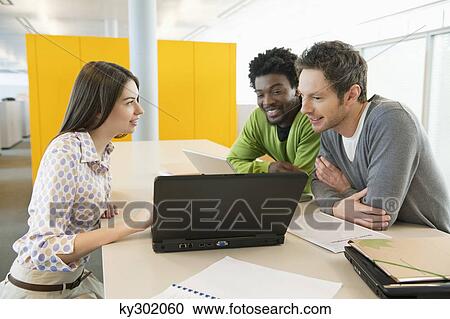 Business executives using laptops in an office View Large Photo Image Stock Image - Business executives using laptops in an office. Fotosearch