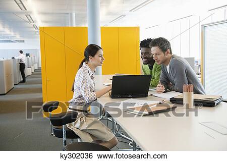 Business executives using laptops in an office View Large Photo Image Stock Photograph - Business executives using laptops in an office. Fotosearch