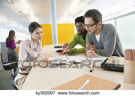 Stock Photo - Business executives working in an office. Fotosearch