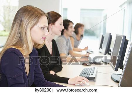 Stock Image - Business executives working on computers in a training class. Fotosearch