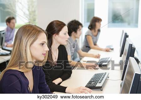 Stock Photo - Business executives working on computers in a training class. Fotosearch