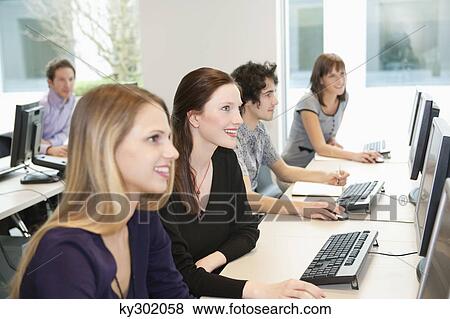 Stock Photo - Business executives working on computers in a training class. Fotosearch