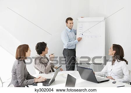 Picture - Businessman giving presentation in a meeting. Fotosearch