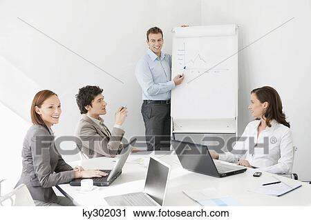 Businessman giving presentation in a meeting View Large Photo Image Stock Image - Businessman giving presentation in a meeting. Fotosearch
