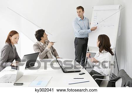Businessman giving presentation in a meeting View Large Photo Image Stock Image - Businessman giving presentation in a meeting. Fotosearch