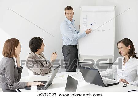 Stock Photo - Businessman giving presentation in a meeting. Fotosearch