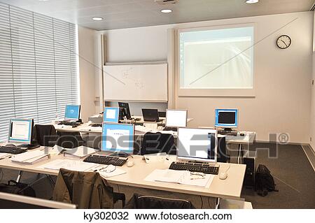 Computers on tables in a classroom View Large Photo Image Stock Image - Computers on tables in a classroom. Fotosearch