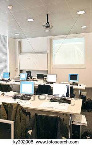 Stock Photo - Computers on tables in a classroom. Fotosearch