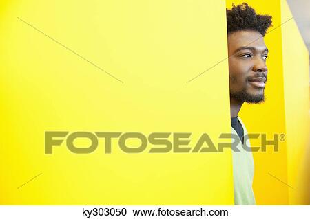 Stock Image - Businessman day dreaming in an office. Fotosearch