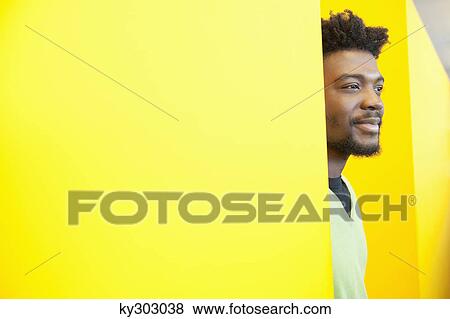 Stock Photo - Businessman day dreaming in an office. Fotosearch