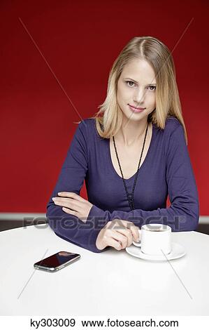 Businesswoman drinking tea in an office View Large Photo Image Stock Photo - Businesswoman drinking tea in an office. Fotosearch