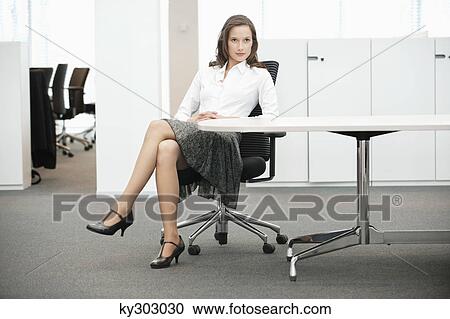 Businesswoman sitting in an office View Large Photo Image Stock Image - Businesswoman sitting in an office. Fotosearch