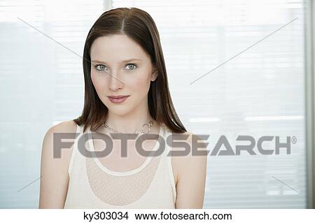 Businesswoman smiling in an office View Large Photo Image Picture - Businesswoman smiling in an office. Fotosearch