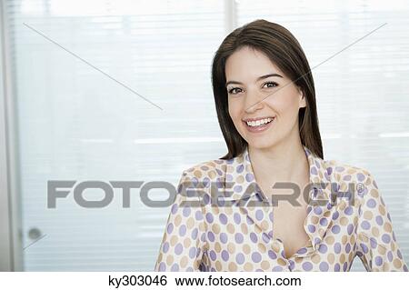 Businesswoman smiling in an office View Large Photo Image Stock Photograph - Businesswoman smiling in an office. Fotosearch
