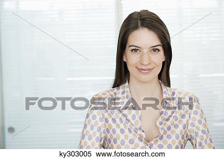 Businesswoman smiling in an office View Large Photo Image Stock Photography - Businesswoman smiling in an office. Fotosearch