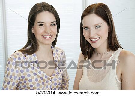 Businesswomen smiling in an office View Large Photo Image Picture - Businesswomen smiling in an office. Fotosearch