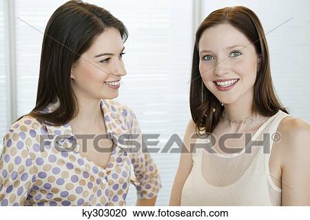Businesswomen smiling in an office View Large Photo Image Stock Image - Businesswomen smiling in an office. Fotosearch