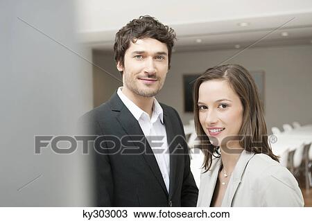 Portrait of a businesswoman smiling with her colleague beside her View Large Photo Image Stock Image - Portrait of a businesswoman smiling with her colleague beside her. Fotosearch