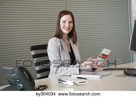 Businesswoman doing paperwork in an office View Large Photo Image Picture - Businesswoman doing paperwork in an office. Fotosearch