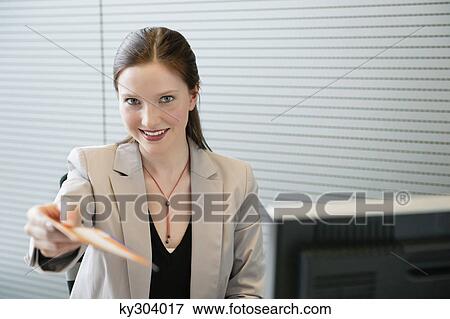 Businesswoman giving an envelope View Large Photo Image Stock Photo - Businesswoman giving an envelope. Fotosearch
