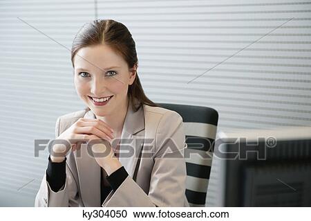 Businesswoman sitting in an office View Large Photo Image Stock Image - Businesswoman sitting in an office. Fotosearch