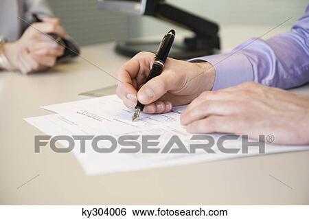 Stock Image - Man signing documents. Fotosearch - Search Stock Photography, Poster Photos, Pictures, and Photo Clip Art