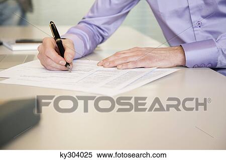 Stock Photography - Man signing documents. Fotosearch