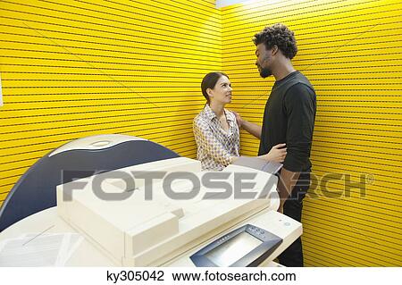 Business couple romancing near a photocopy machine View Large Photo Image Stock Image - Business couple romancing near a photocopy machine. Fotosearch