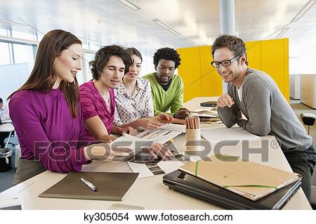 Picture - Business executives discussing in an office. Fotosearch
