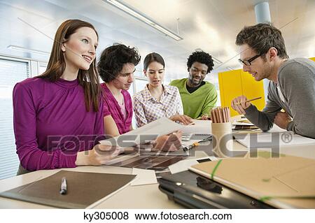 Business executives discussing in an office View Large Photo Image Stock Photo - Business executives discussing in an office. Fotosearch