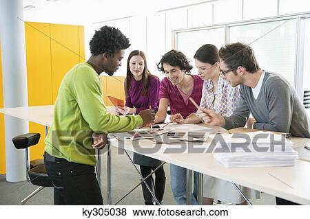 Business executives discussing in an office View Large Photo Image Stock Photo - Business executives discussing in an office. Fotosearch