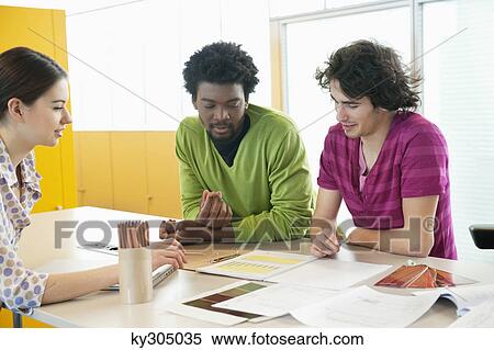Business executives discussing in an office View Large Photo Image Stock Photography - Business executives discussing in an office. Fotosearch