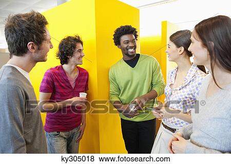 Stock Photo - Business executives drinking tea in an office. Fotosearch