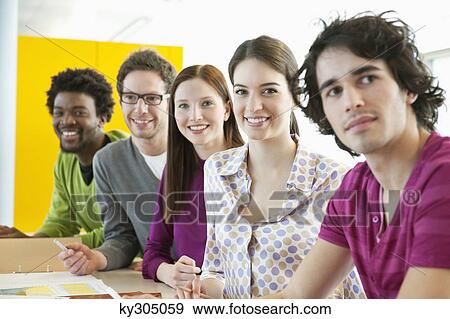 Business executives smiling in an office View Large Photo Image Stock Photo - Business executives smiling in an office. Fotosearch