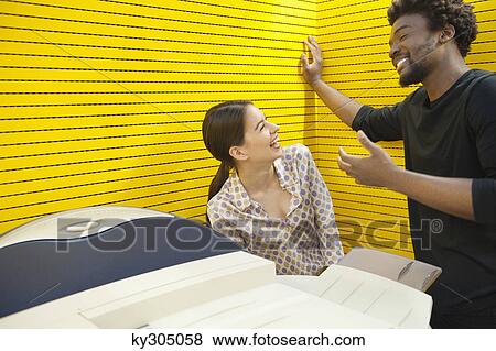 Business executives standing near photocopy machine and smiling View Large Photo Image Stock Photo - Business executives standing near photocopy machine and smiling. Fotosearch