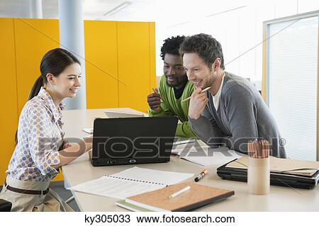 Business executives using laptops in an office View Large Photo Image Stock Image - Business executives using laptops in an office. Fotosearch