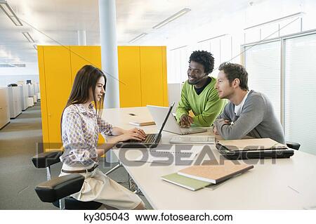 Business executives using laptops in an office View Large Photo Image Stock Image - Business executives using laptops in an office. Fotosearch