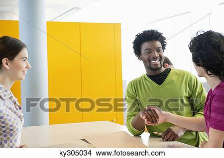 Businessmen shaking hands in an office View Large Photo Image Picture - Businessmen shaking hands in an office. Fotosearch
