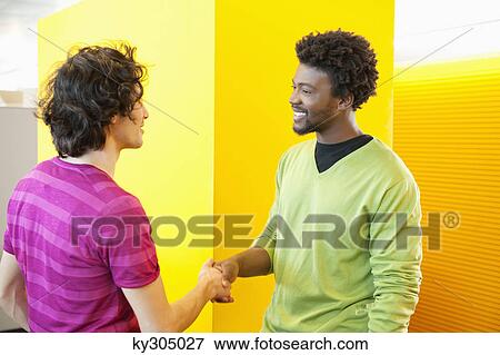 Businessmen shaking hands in an office View Large Photo Image Stock Photo - Businessmen shaking hands in an office. Fotosearch