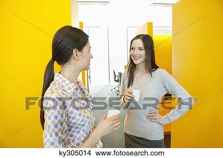 Businesswomen drinking tea in an office View Large Photo Image Picture - Businesswomen drinking tea in an office. Fotosearch