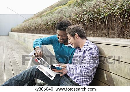 Stock Image - Friends choosing color swatches. Fotosearch