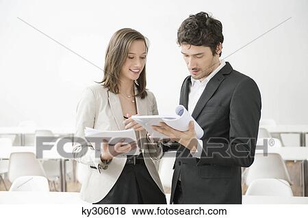 Stock Photo - Business executives discussing a document. Fotosearch