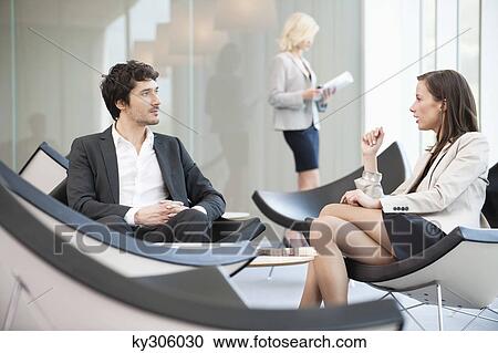Business executives discussing in a waiting room View Large Photo Image Stock Image - Business executives discussing in a waiting room. Fotosearch
