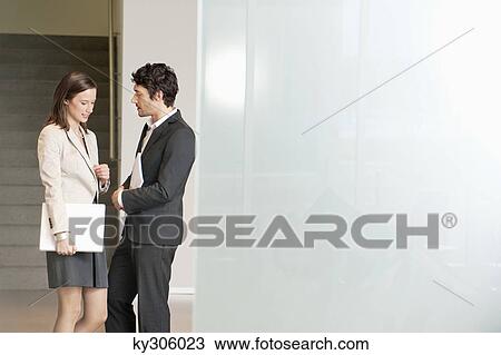 Business executives discussing in an office View Large Photo Image Stock Image - Business executives discussing in an office. Fotosearch